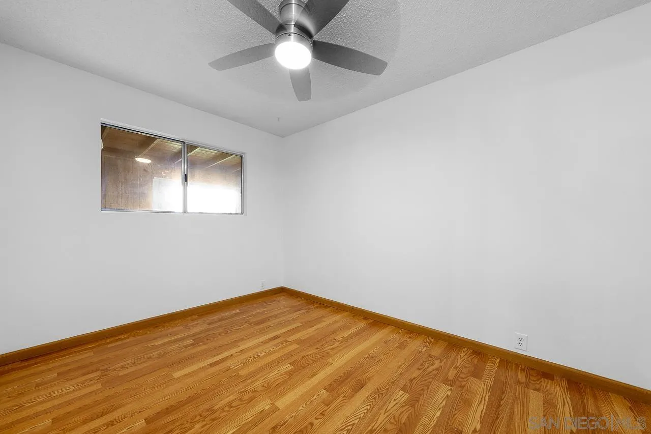 966 27th Street San Diego, CA 92154 - Photo 13 of 33 an empty room with a window and a ceiling fan