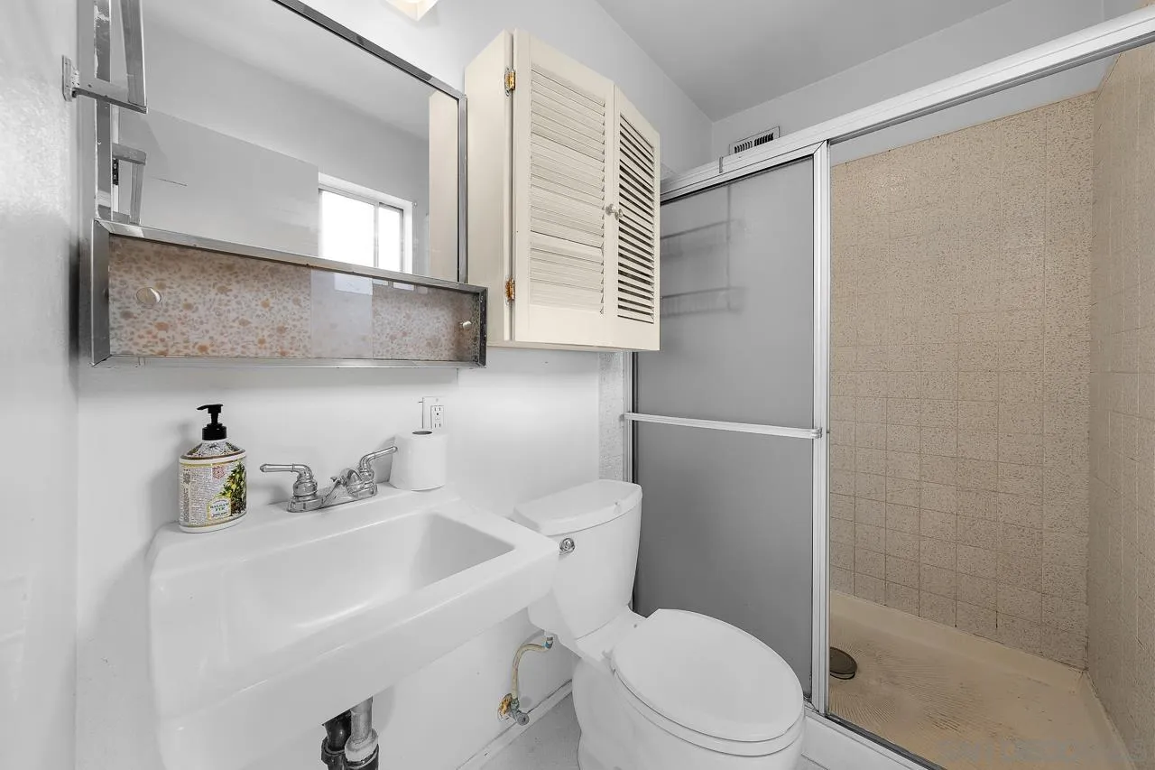 966 27th Street San Diego, CA 92154 - Photo 14 of 33 a bathroom with a sink toilet and shower