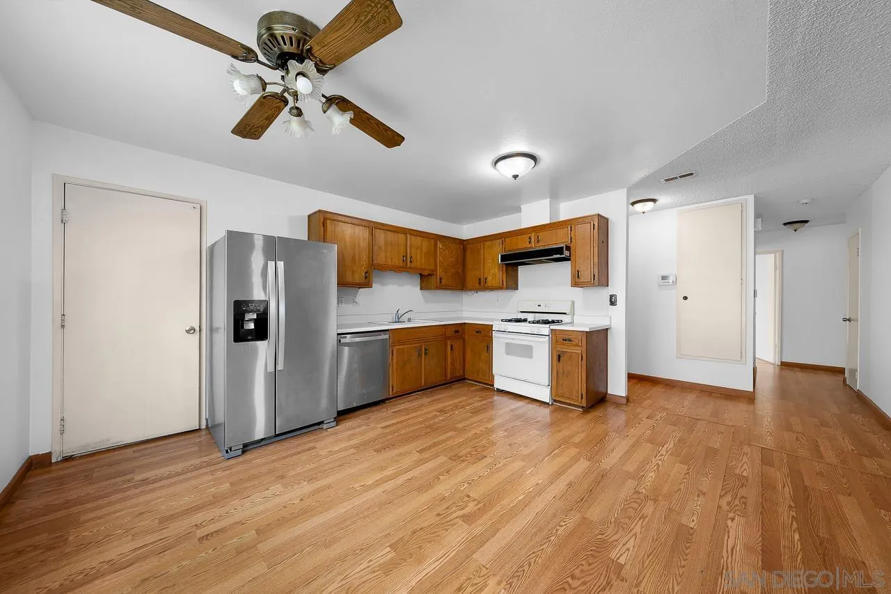 966 27th Street San Diego, CA 92154 - Photo 21 of 33 a kitchen with stainless steel appliances a refrigerator and a stove top oven