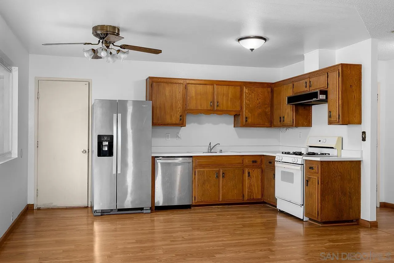 966 27th Street San Diego, CA 92154 - Photo 26 of 33 a kitchen with stainless steel appliances granite countertop a refrigerator a stove top oven a sink and dishwasher