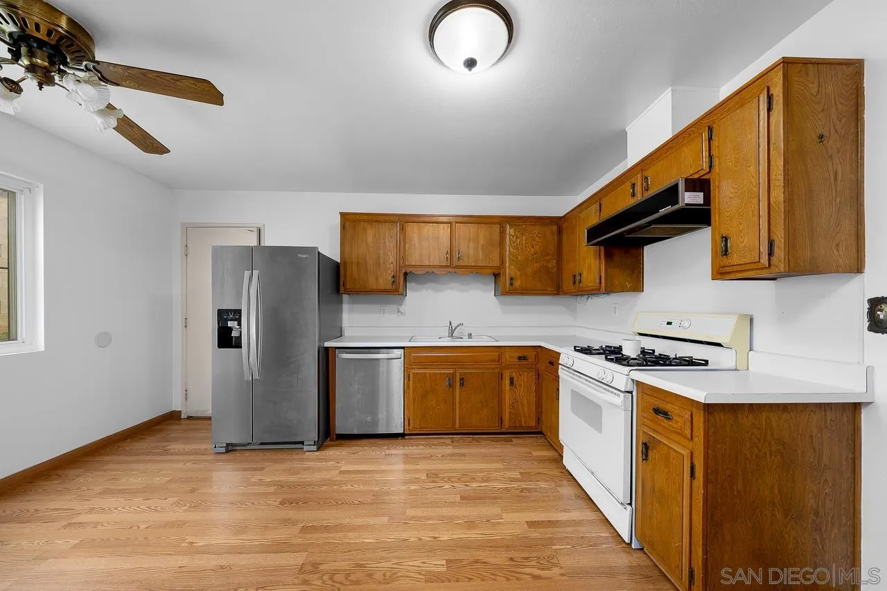 966 27th Street San Diego, CA 92154 - Photo 27 of 33 a kitchen with stainless steel appliances granite countertop a stove a sink dishwasher and a refrigerator