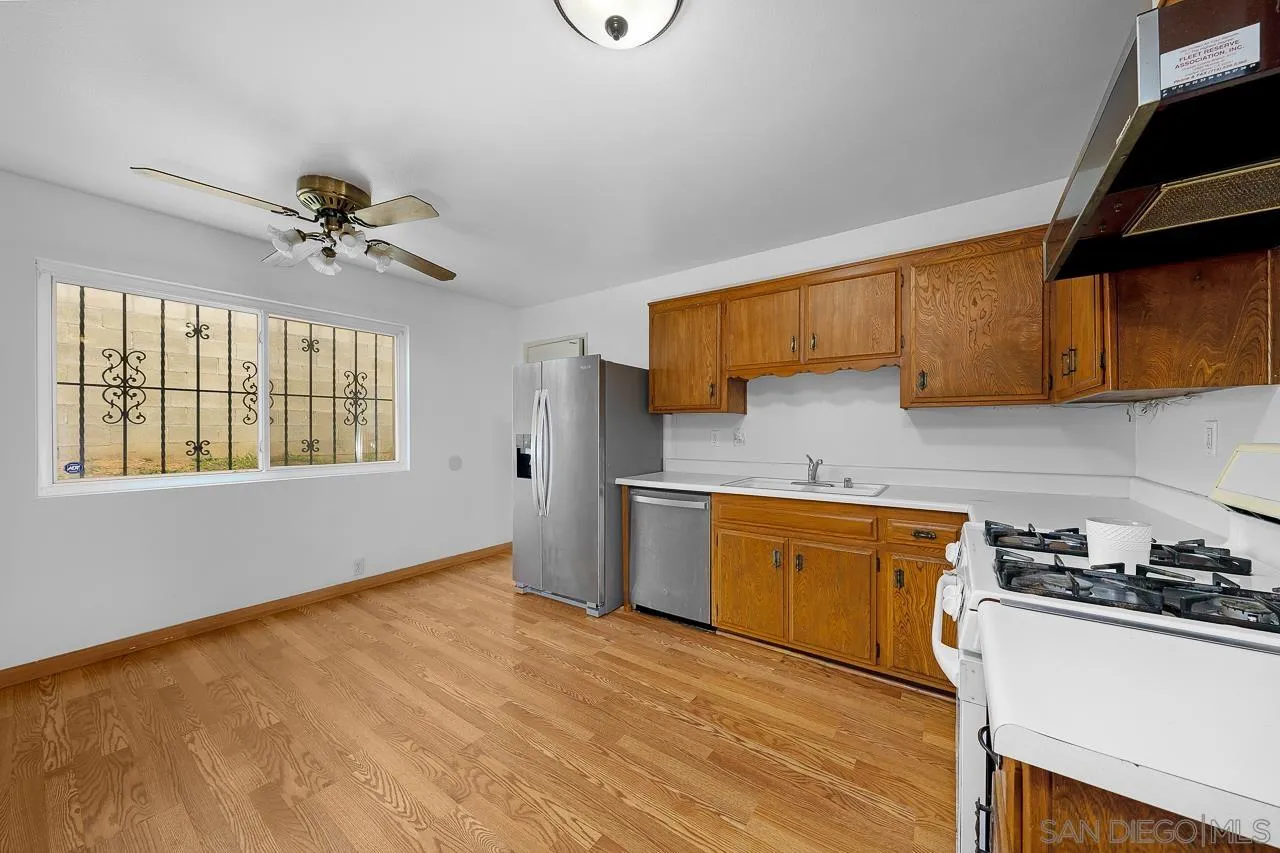 966 27th Street San Diego, CA 92154 - Photo 28 of 33 a kitchen with stainless steel appliances granite countertop a sink cabinets stove and refrigerator