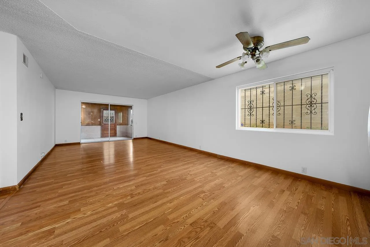 966 27th Street San Diego, CA 92154 - Photo 29 of 33 a view of empty room with wooden floor and fan