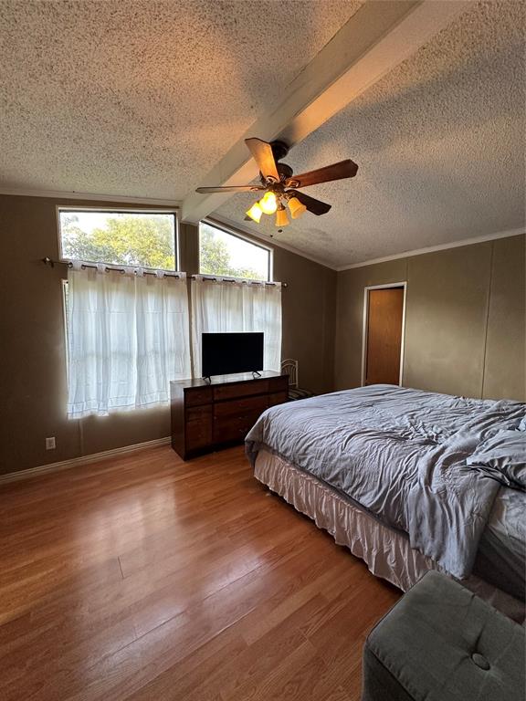 1048 Red Bird Seven Points, TX 75143 - Photo 15 of 28 a spacious bedroom with a bed and a television