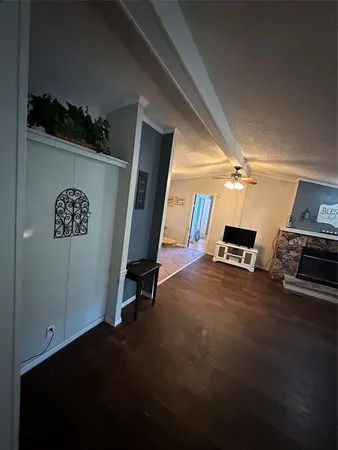 a living room with furniture a flat screen tv and a table