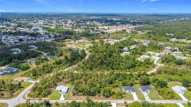 an aerial view of a houses with city view