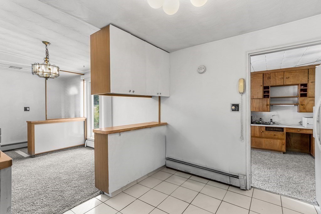 7 Ruth Drive Framingham, MA 01701 - Photo 11 of 33 a view of a kitchen with a refrigerator and cabinets