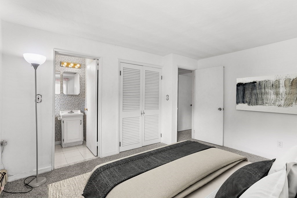 7 Ruth Drive Framingham, MA 01701 - Photo 16 of 33 a bedroom with a bed and a painting on the wall