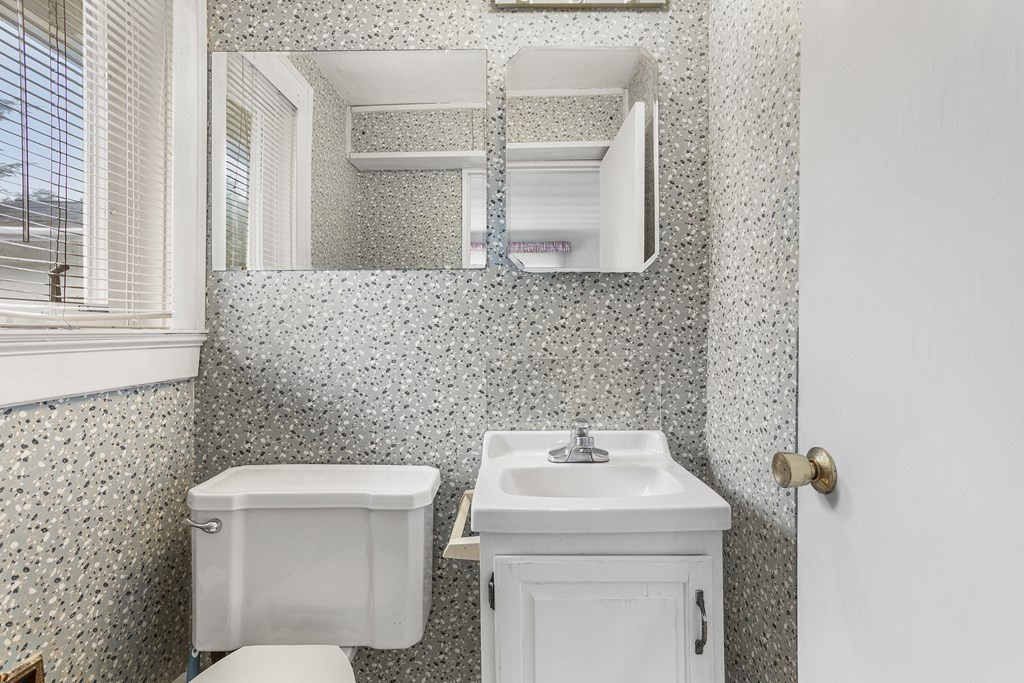 7 Ruth Drive Framingham, MA 01701 - Photo 19 of 33 a bathroom with a toilet sink and mirror