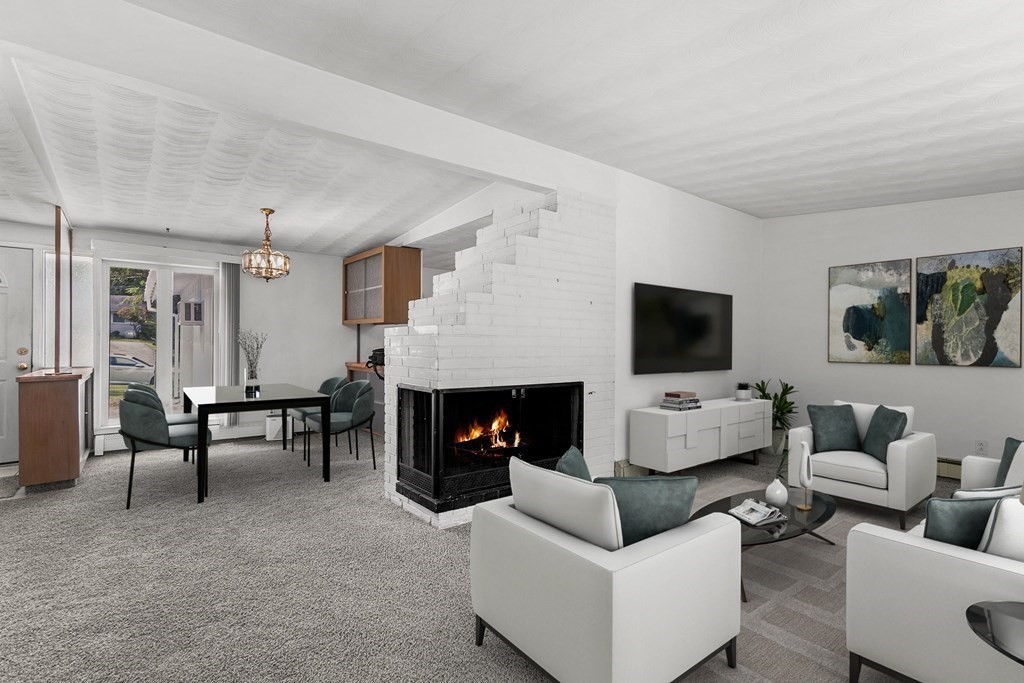 7 Ruth Drive Framingham, MA 01701 - Photo 5 of 33 a living room with furniture flat screen tv and a fireplace