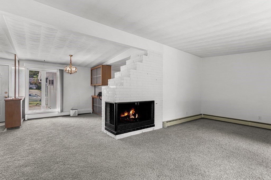 7 Ruth Drive Framingham, MA 01701 - Photo 6 of 33 a view of an empty room with a fireplace