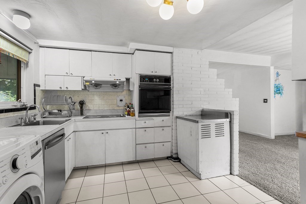 7 Ruth Drive Framingham, MA 01701 - Photo 10 of 33 a kitchen with a sink cabinets and window