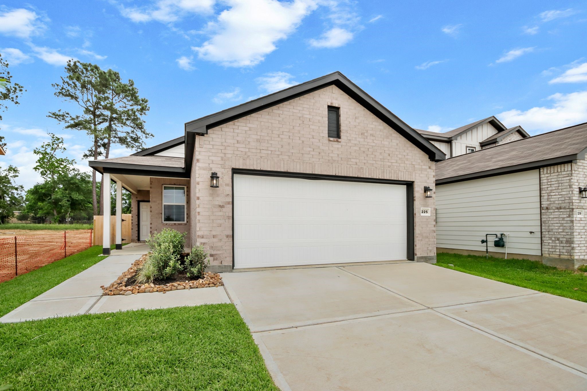 225 Spring Drive Hockley, TX 77447 - Photo 2 of 24 a front view of house with garage and yard