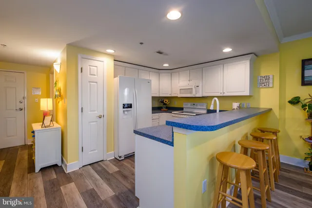a living room with kitchen island furniture and a kitchen view