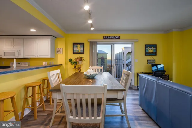 a living room with furniture a chandelier and a dining table