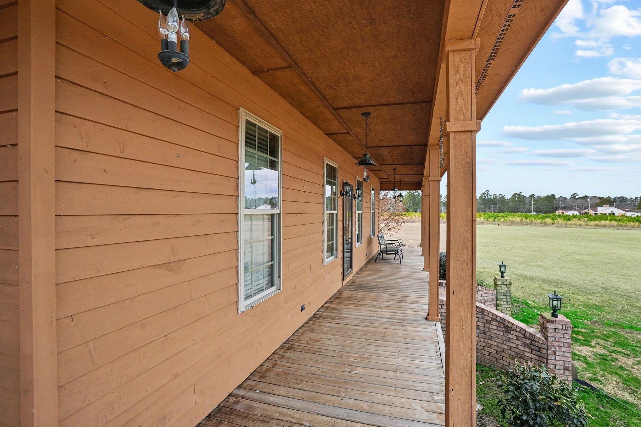 202 Highway 747 Loris Sc 29569 Loris, SC 29569 - Photo 28 of 34 Porch featuring a lawn