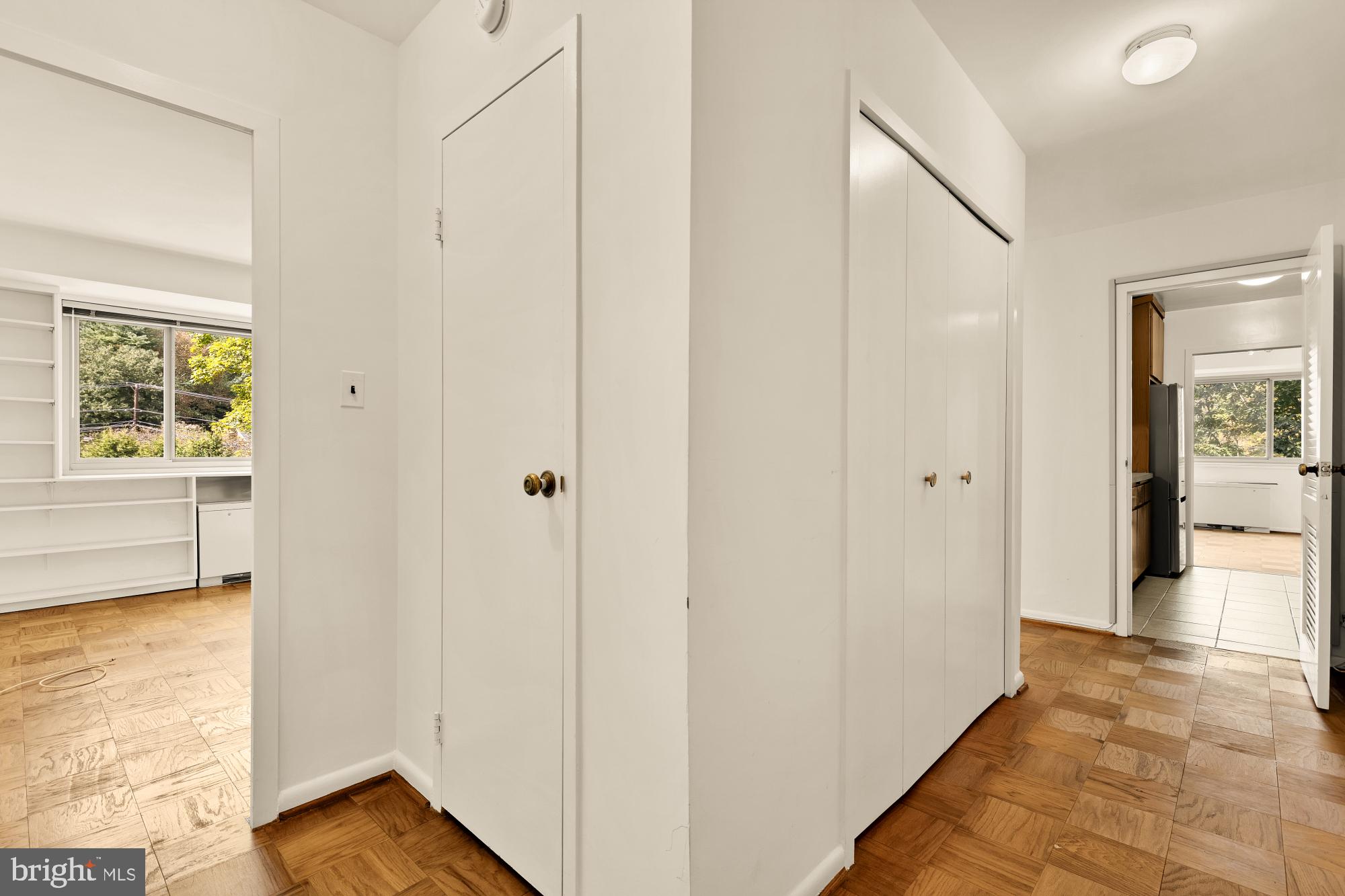 5100 Dorset Avenue, Unit 308 Chevy Chase, MD 20815 - Photo 13 of 31 a view of a hallway with wooden floor and a living room