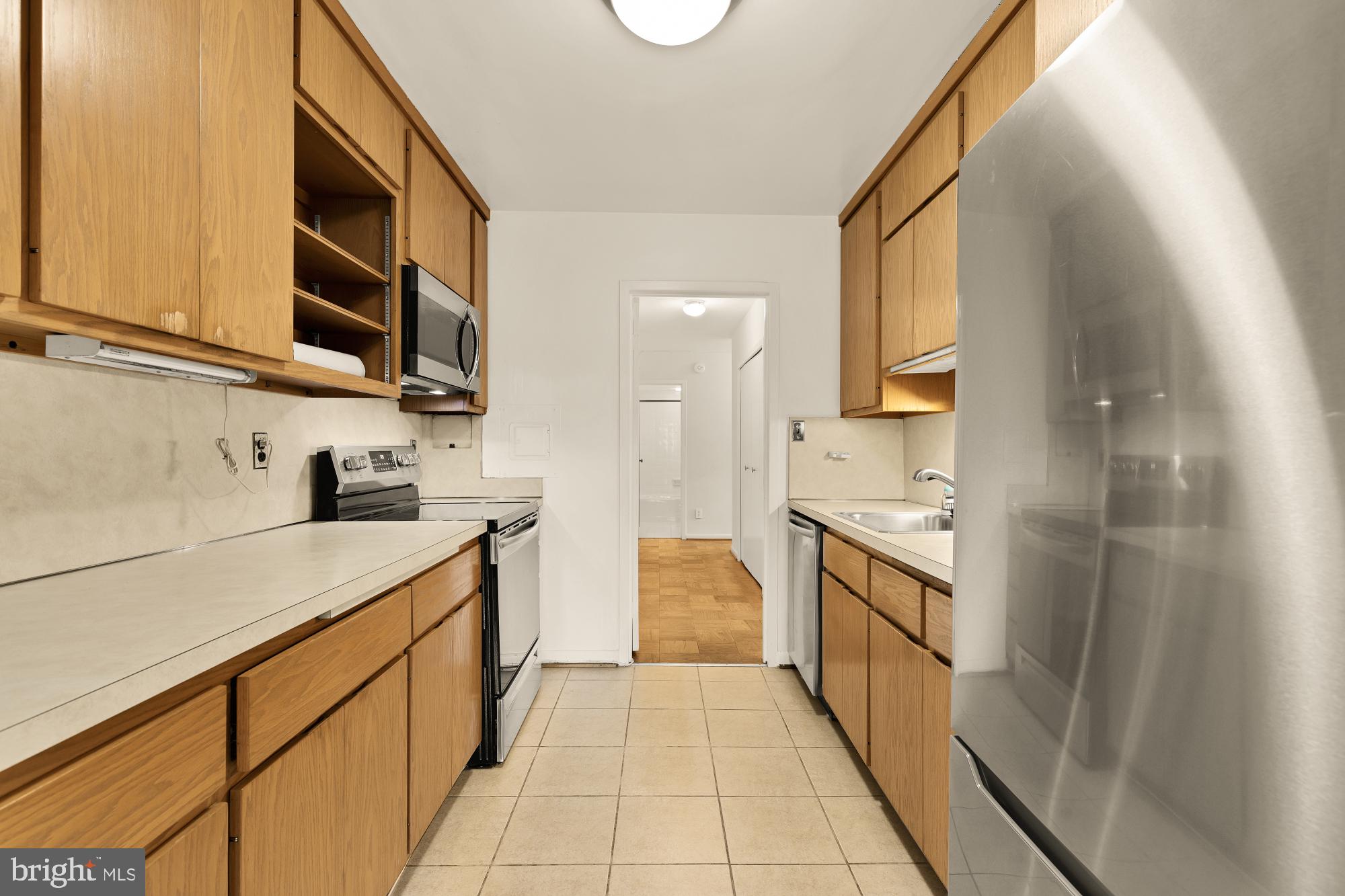5100 Dorset Avenue, Unit 308 Chevy Chase, MD 20815 - Photo 5 of 31 a kitchen with stainless steel appliances granite countertop a sink and cabinets