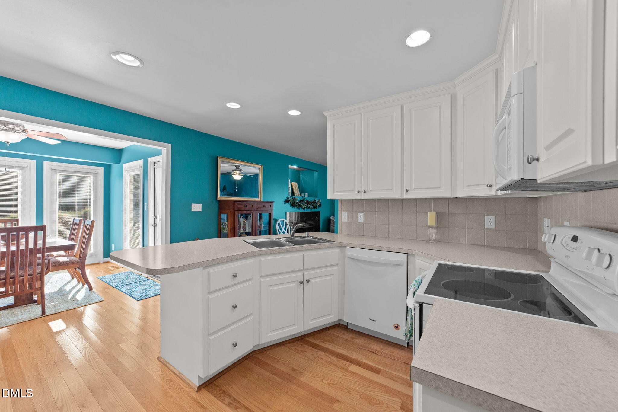 1208 Peach Orchard Road Four Oaks, NC 27524 - Photo 25 of 63 a kitchen with white cabinets and sink