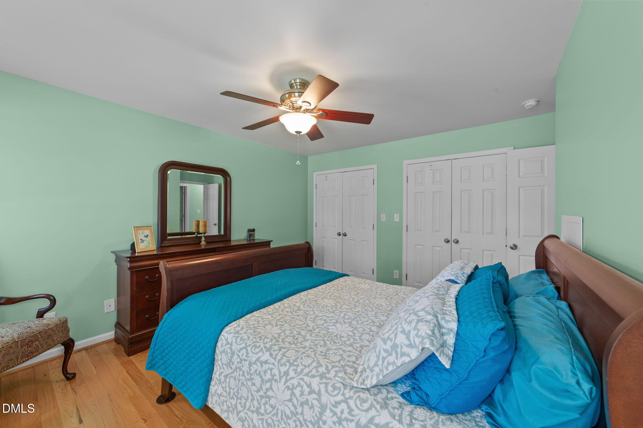 1208 Peach Orchard Road Four Oaks, NC 27524 - Photo 32 of 63 a bedroom with a bed and a chandelier