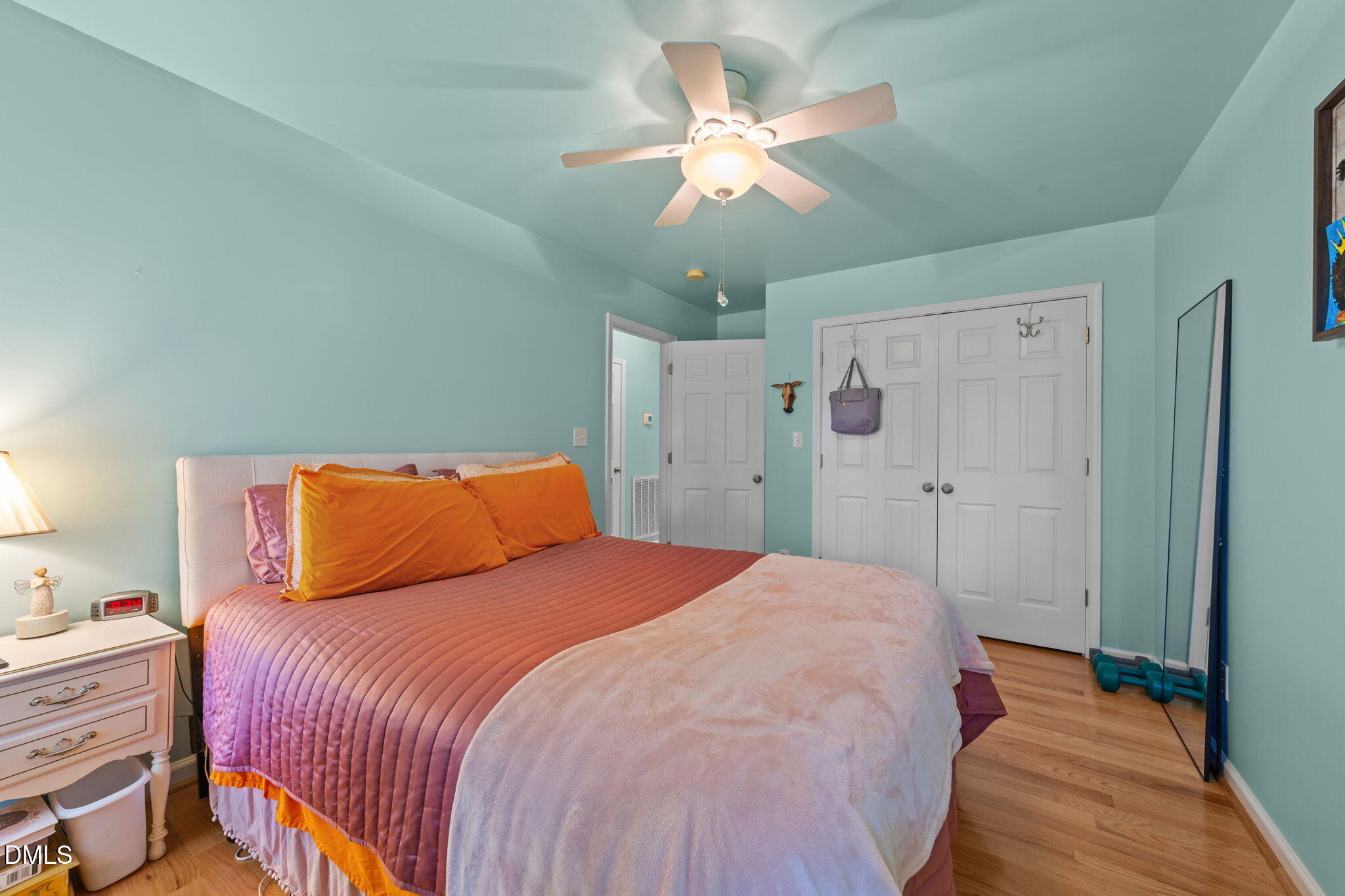 1208 Peach Orchard Road Four Oaks, NC 27524 - Photo 36 of 63 a bedroom with a large bed and a chandelier
