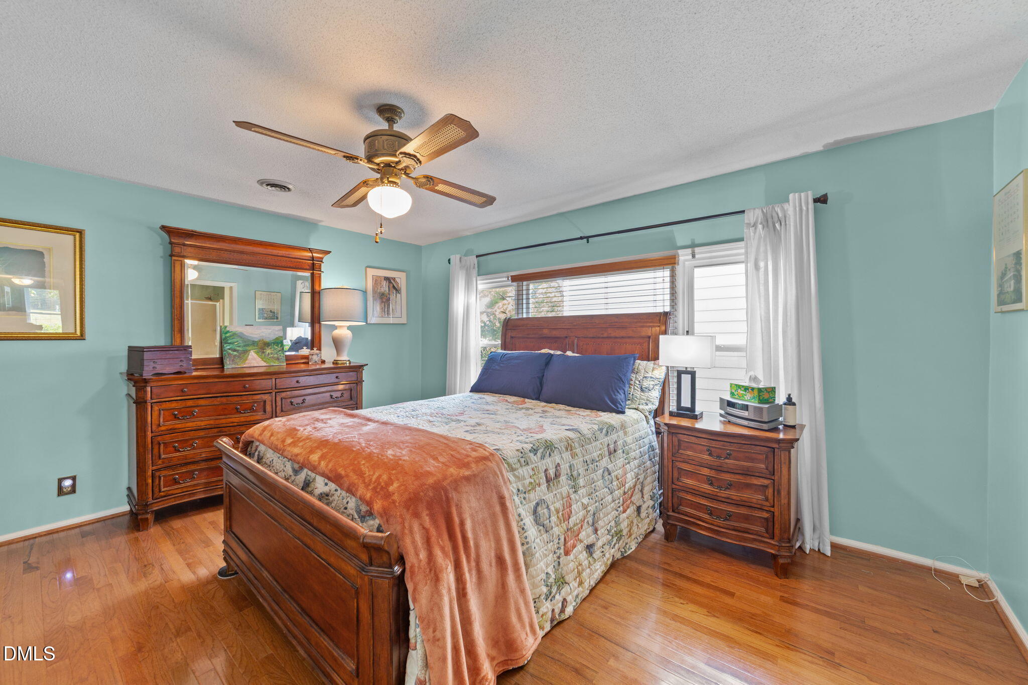 1208 Peach Orchard Road Four Oaks, NC 27524 - Photo 40 of 63 a bedroom with a bed and a dresser with wooden floor