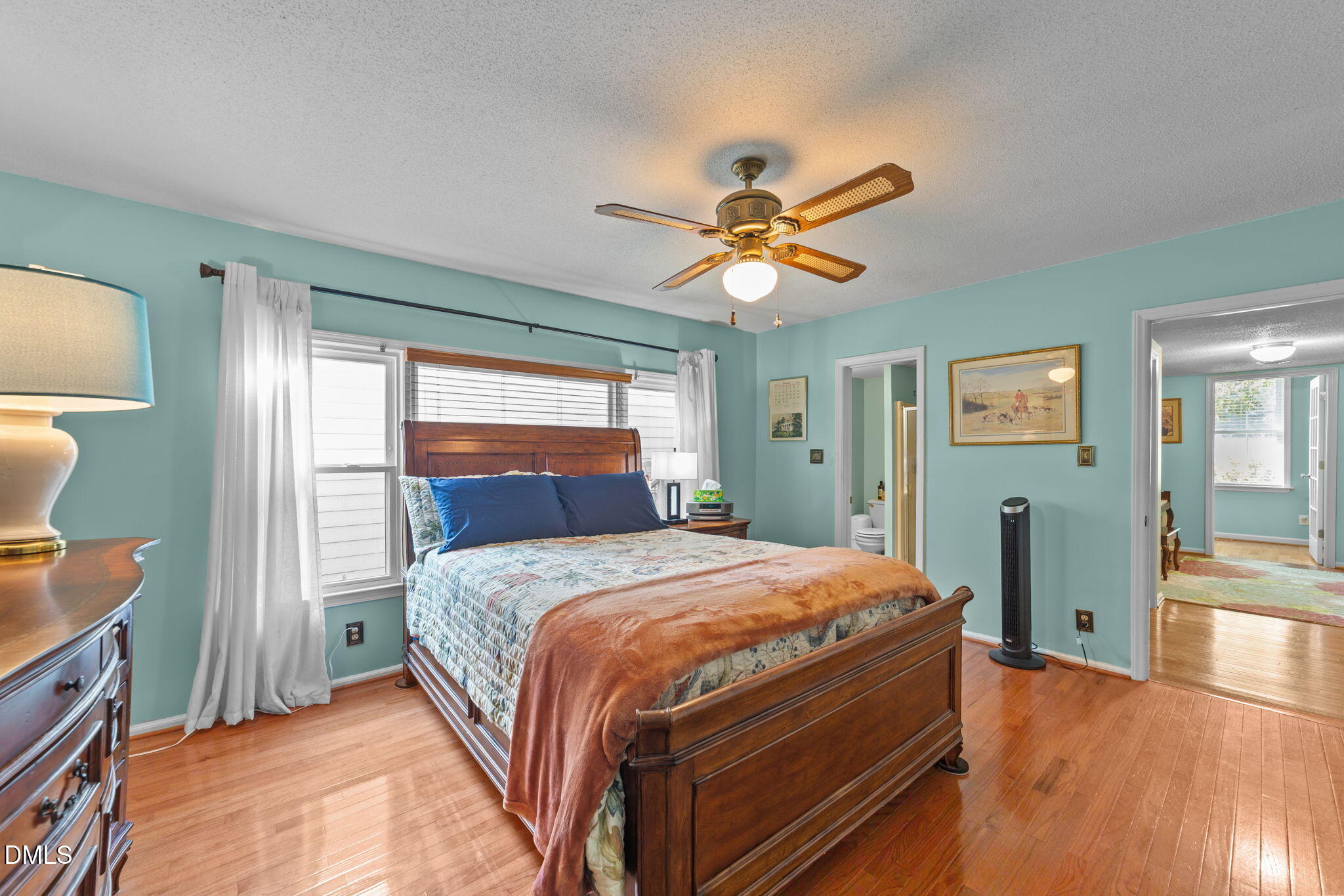 1208 Peach Orchard Road Four Oaks, NC 27524 - Photo 41 of 63 a bedroom with a bed and a chandelier