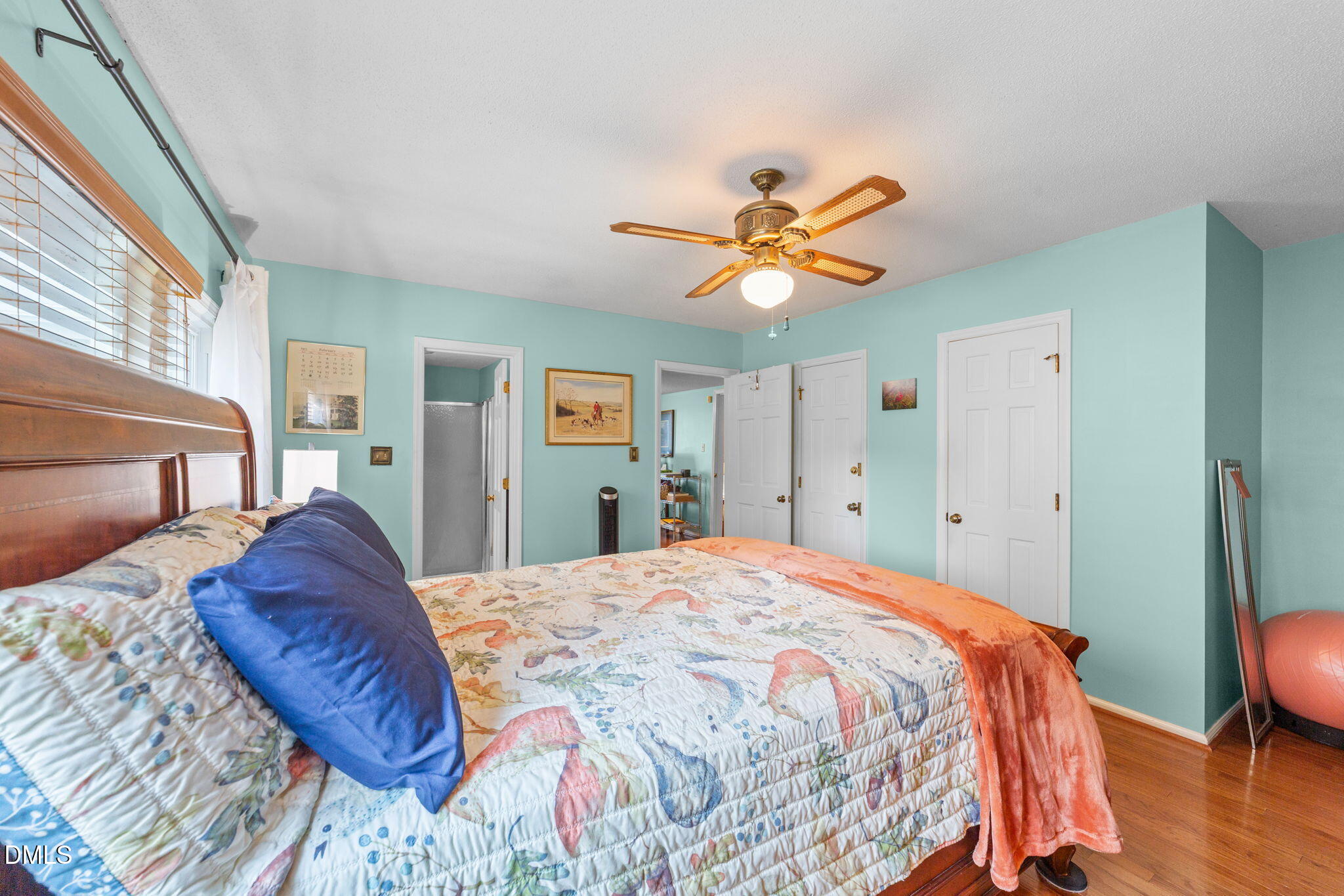 1208 Peach Orchard Road Four Oaks, NC 27524 - Photo 42 of 63 a bedroom with a bed and a chandelier