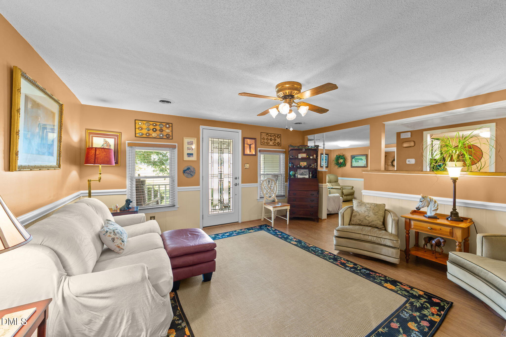 1208 Peach Orchard Road Four Oaks, NC 27524 - Photo 50 of 63 a living room with furniture and a chandelier