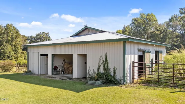 a view of a house with backyard porch and sitting area