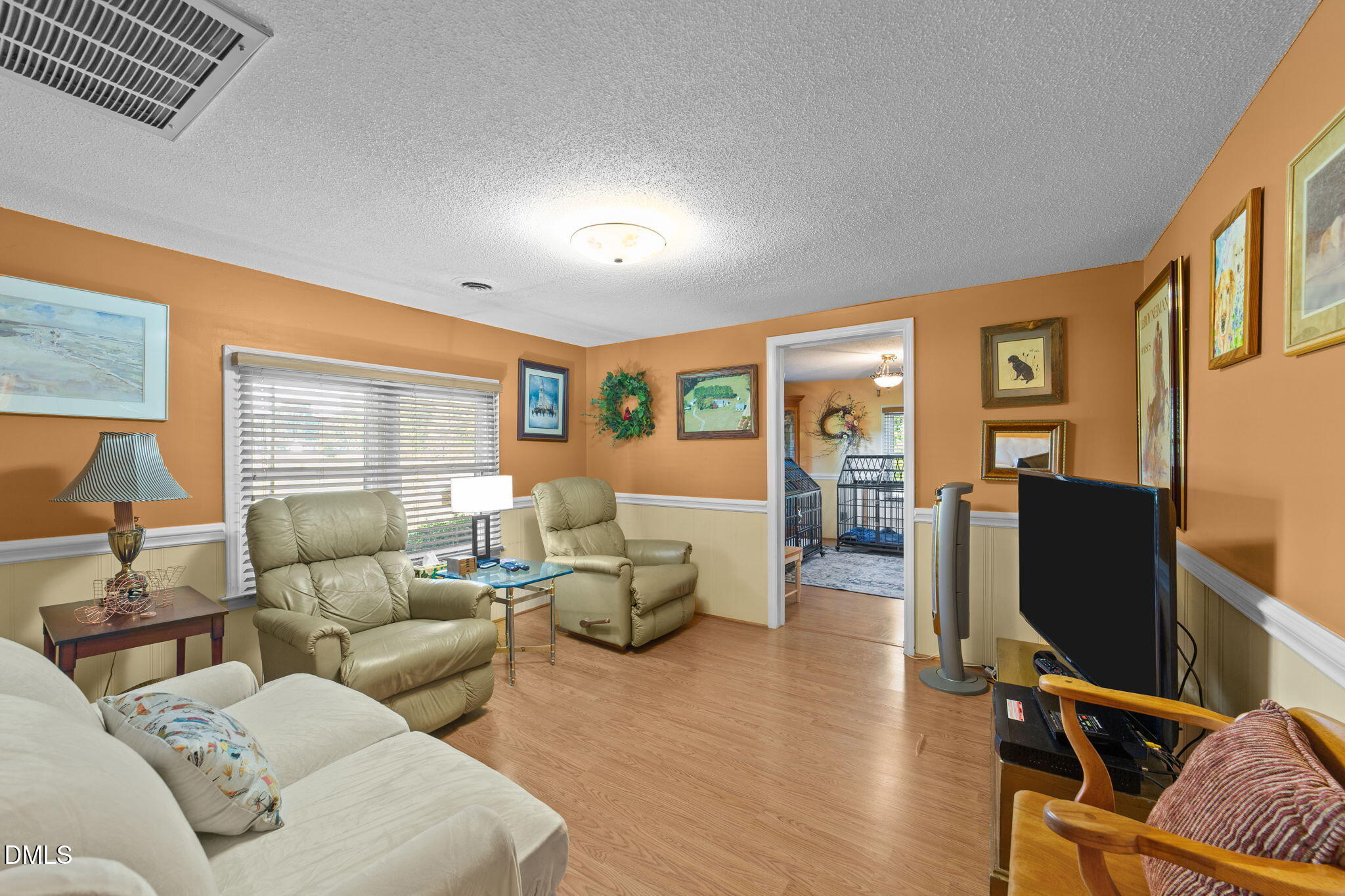 1208 Peach Orchard Road Four Oaks, NC 27524 - Photo 52 of 63 a living room with furniture gym equipment and a large window