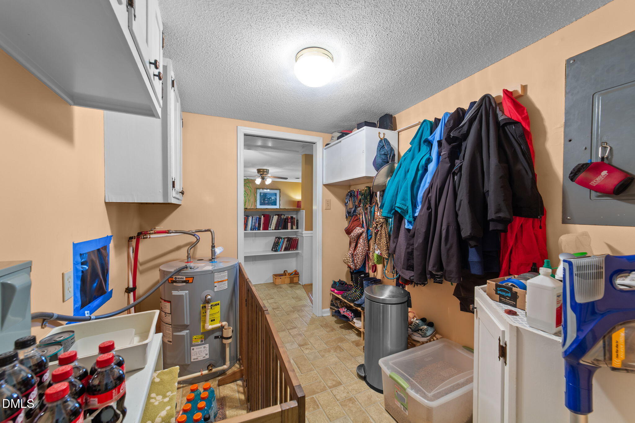 1208 Peach Orchard Road Four Oaks, NC 27524 - Photo 57 of 63 a view of walk in closet with clothes and shoes