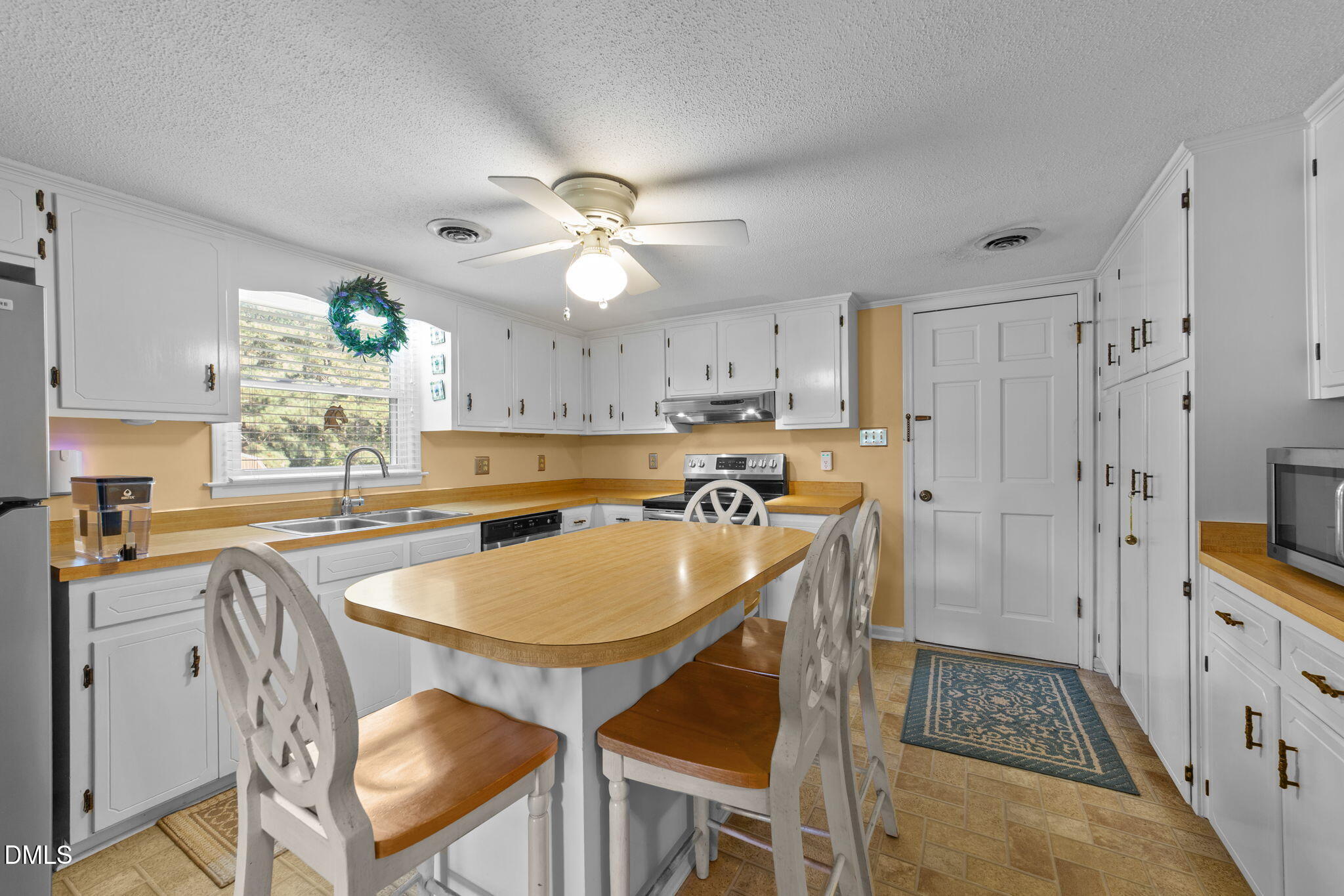 1208 Peach Orchard Road Four Oaks, NC 27524 - Photo 58 of 63 a kitchen with stainless steel appliances granite countertop a stove a sink dishwasher and a refrigerator with wooden floor