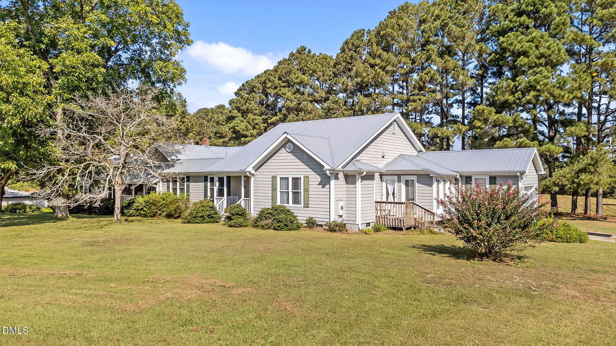 1208 Peach Orchard Road Four Oaks, NC 27524 - Photo 7 of 63 a front view of a house with a garden