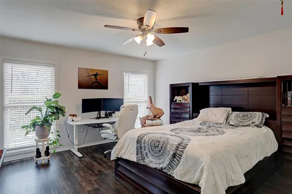 a bedroom with a large bed and a flat tv screen