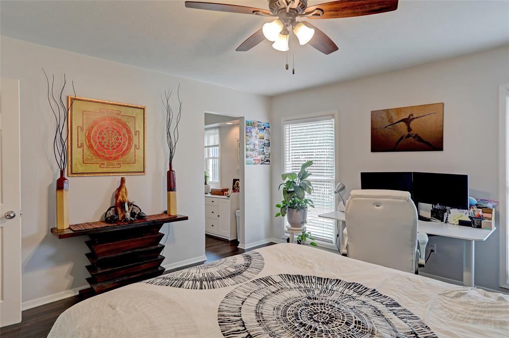 7736 Meadow Road, Unit 102 Dallas, TX 75230 - Photo 14 of 25 Primary bedroom — third angle with ceiling fan and hardwood floors