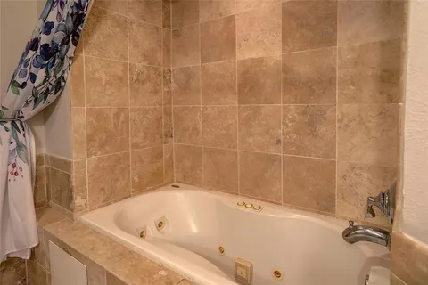 a bathroom with a tub and a shower