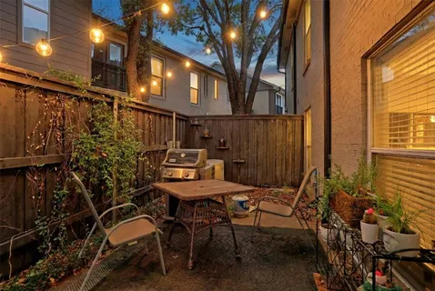 a view of a patio with table and chairs and potted plants