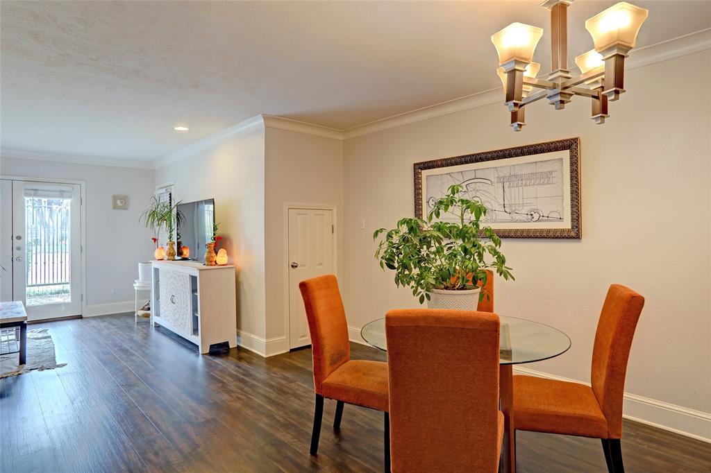 7736 Meadow Road, Unit 102 Dallas, TX 75230 - Photo 7 of 25 Dining area with chandelier and kitchen just beyond