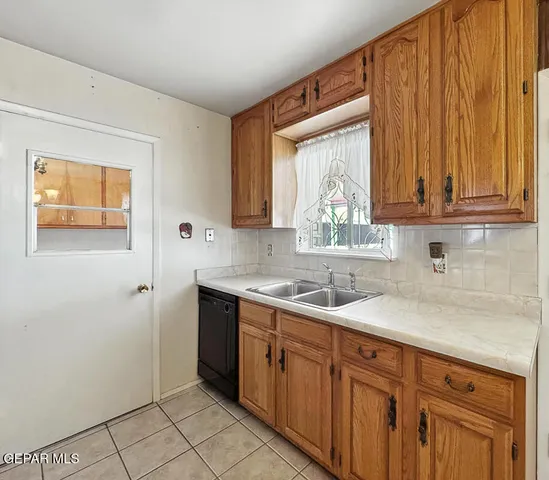 a kitchen with a sink cabinets and window
