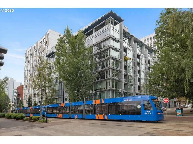 a front view of a building with parked cars