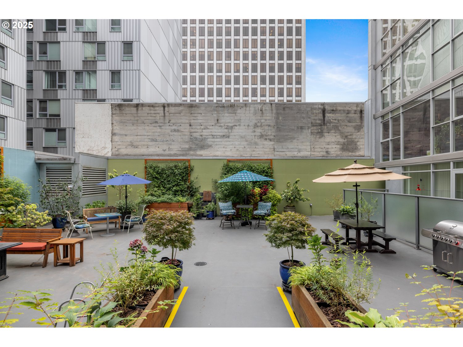 533 Northeast Holladay Street, Unit 601 Portland, OR 97232 - Photo 17 of 25 a view of a patio with table and chairs potted plants