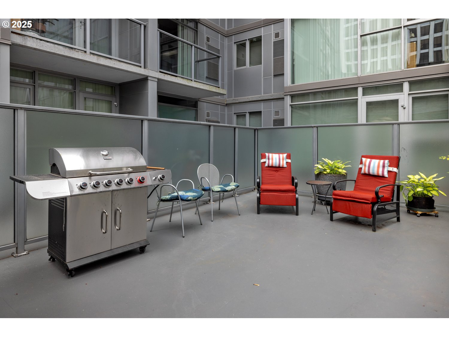 533 Northeast Holladay Street, Unit 601 Portland, OR 97232 - Photo 19 of 25 a backyard of a house with barbeque oven and outdoor seating