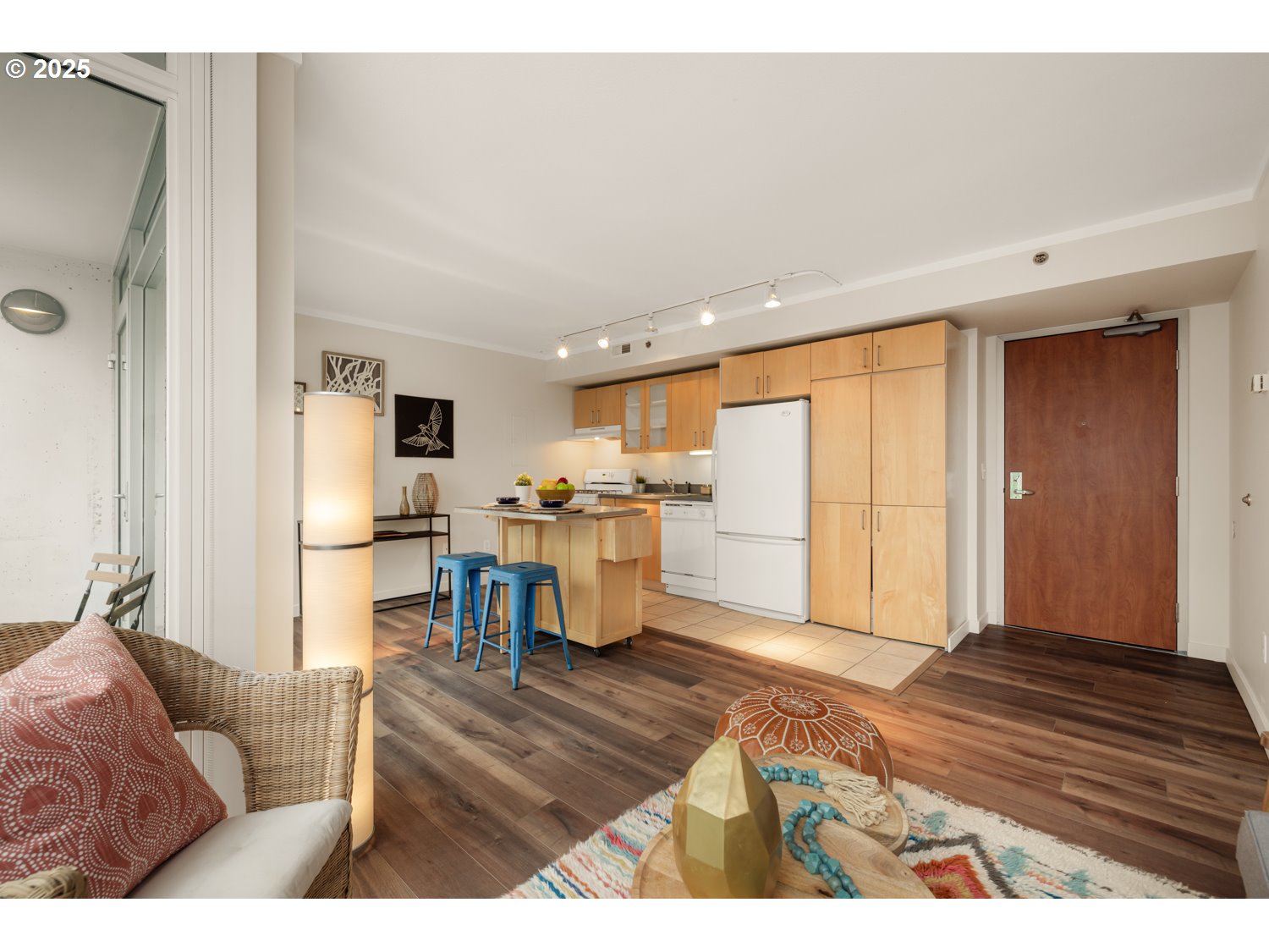 533 Northeast Holladay Street, Unit 601 Portland, OR 97232 - Photo 7 of 25 a living room with furniture and a dining table with kitchen view