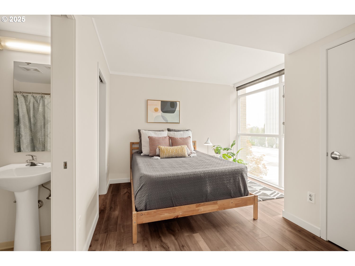 533 Northeast Holladay Street, Unit 601 Portland, OR 97232 - Photo 10 of 25 a bedroom with a bed and a mirror