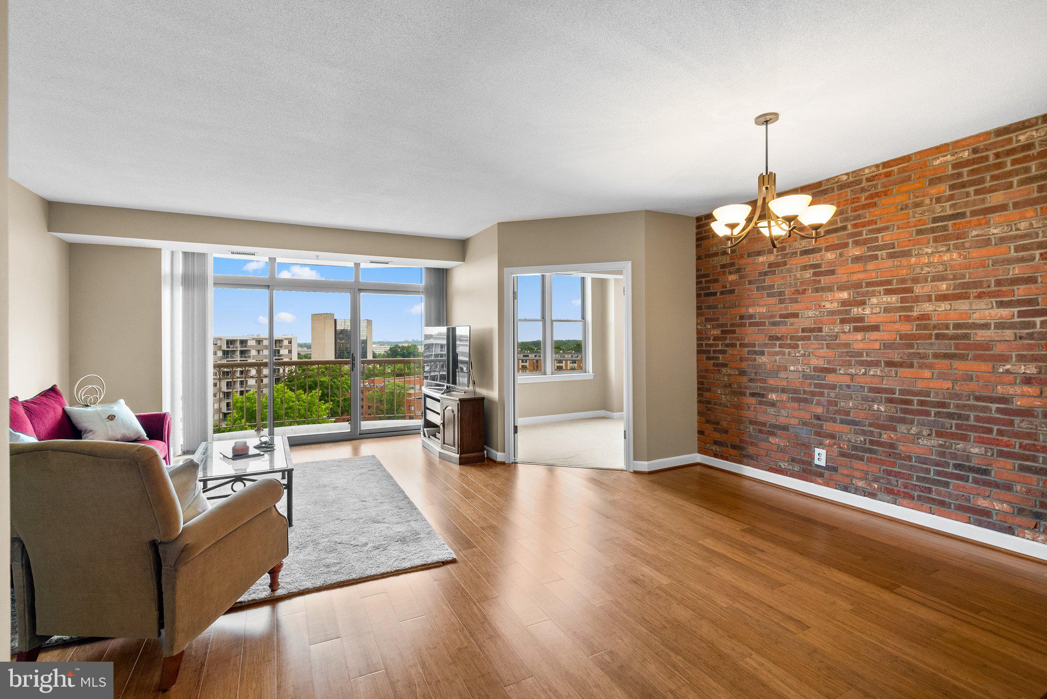 5000 Battery Lane, Unit 905 Bethesda, MD 20814 - Photo 1 of 40 a living room with furniture floor to ceiling window and wooden floor