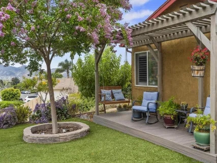 a swimming pool with outdoor seating and plants
