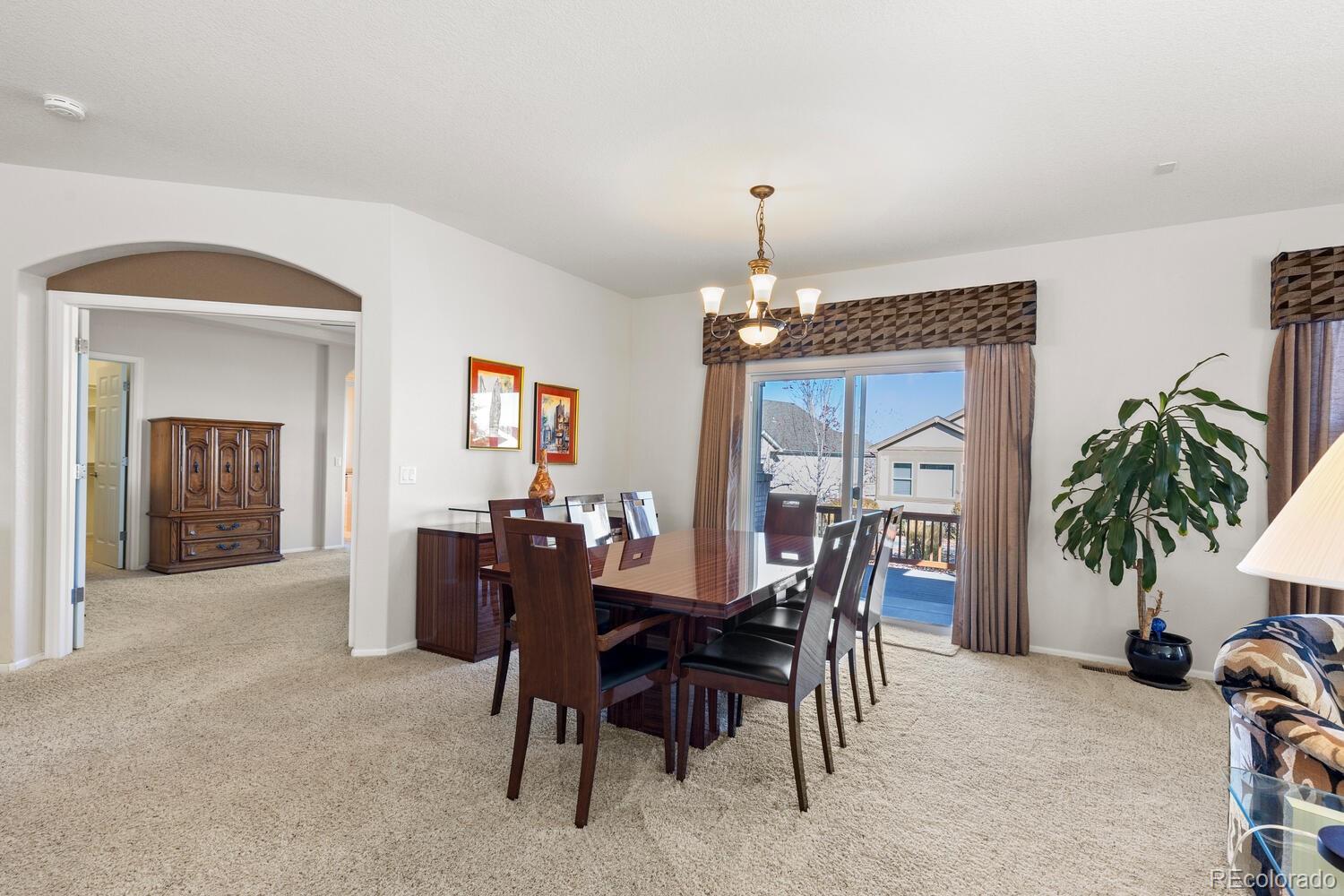 8322 South Quatar Circle Aurora, CO 80016 - Photo 20 of 47 a view of a dining room with furniture and chandelier