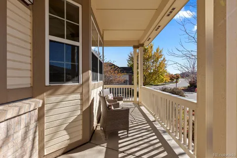 a view of balcony with wooden floor and fence