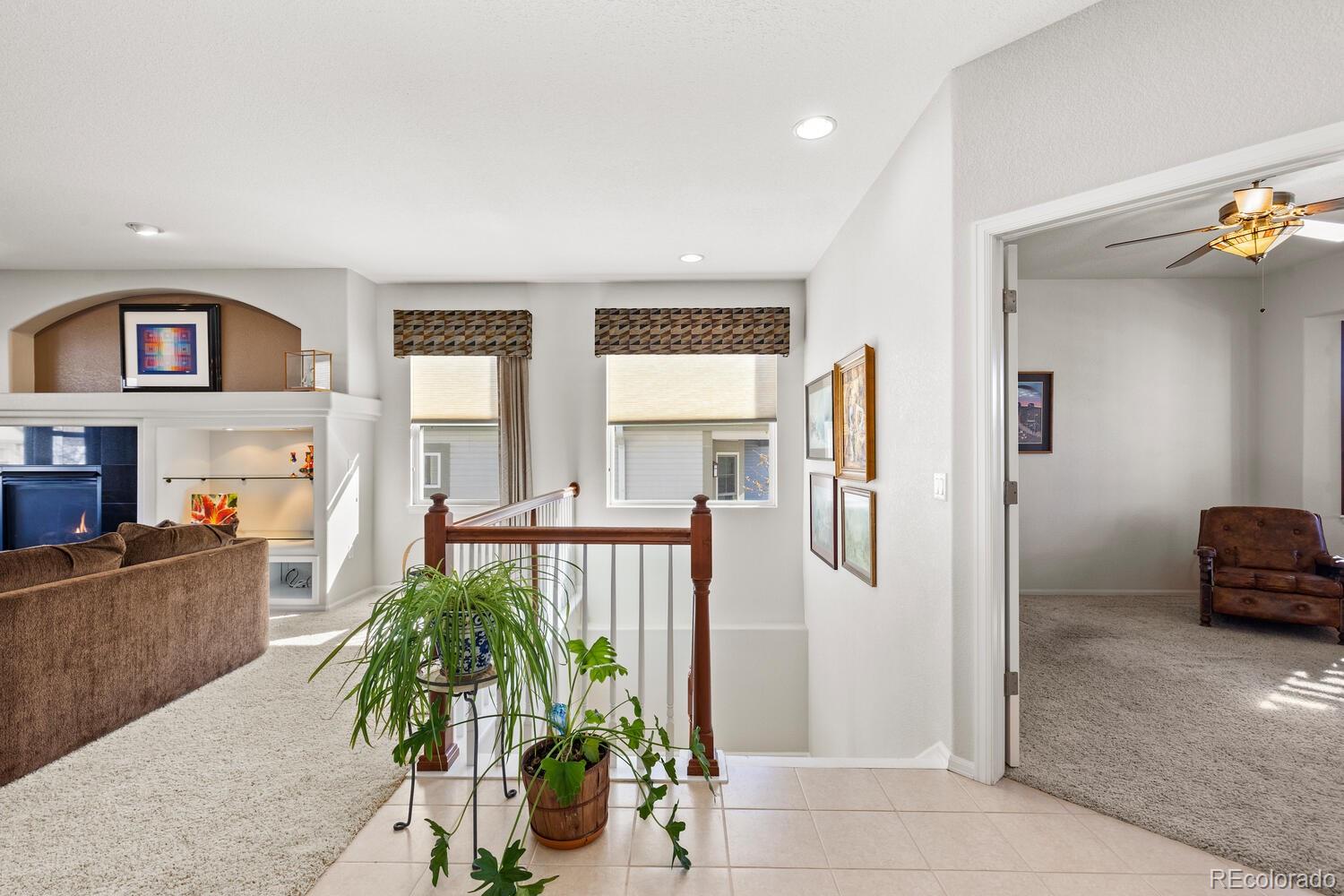8322 South Quatar Circle Aurora, CO 80016 - Photo 6 of 47 a living room with furniture and a potted plant